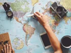 The graphic depicts preparations for a trip: a map, a notebook in one hand, an airplane in the other, and a compass and coffee nearby.